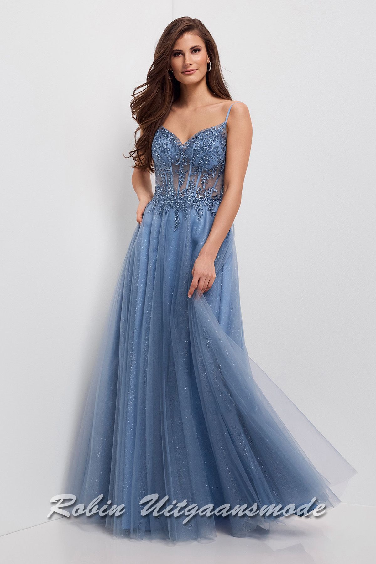Nevelblauwe galajurk met kanten korset top, een semi-transparante taille en lange rok bedekt met glitter tule